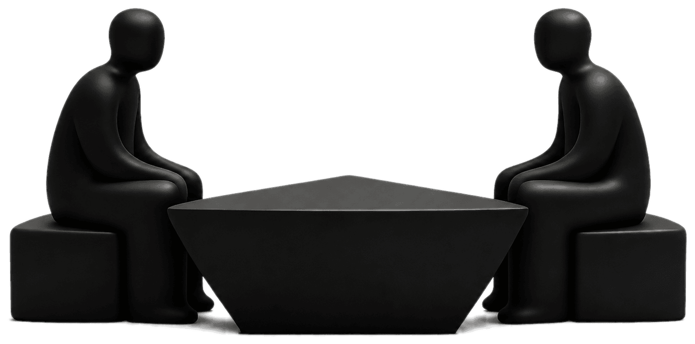 Two sculptural figures seated across a trapezoidal table, facing each other.
